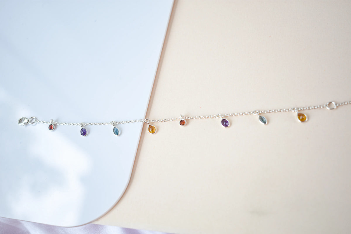 Multi gemstone dangle bracelet with pear-cut colored stones on a 925 silver chain