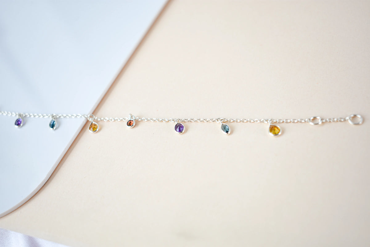 Multi gemstone dangle bracelet with pear-cut colored stones on a 925 silver chain