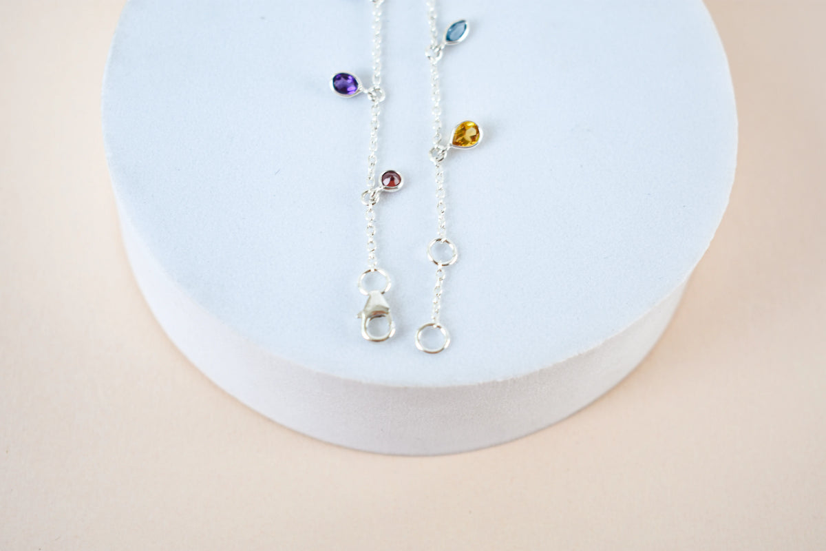 Multi gemstone dangle bracelet with pear-cut colored stones on a 925 silver chain