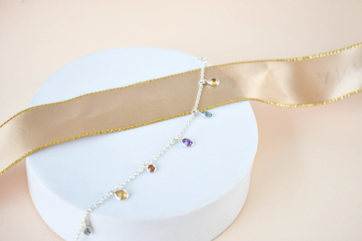 Multi gemstone dangle bracelet with pear-cut colored stones on a 925 silver chain