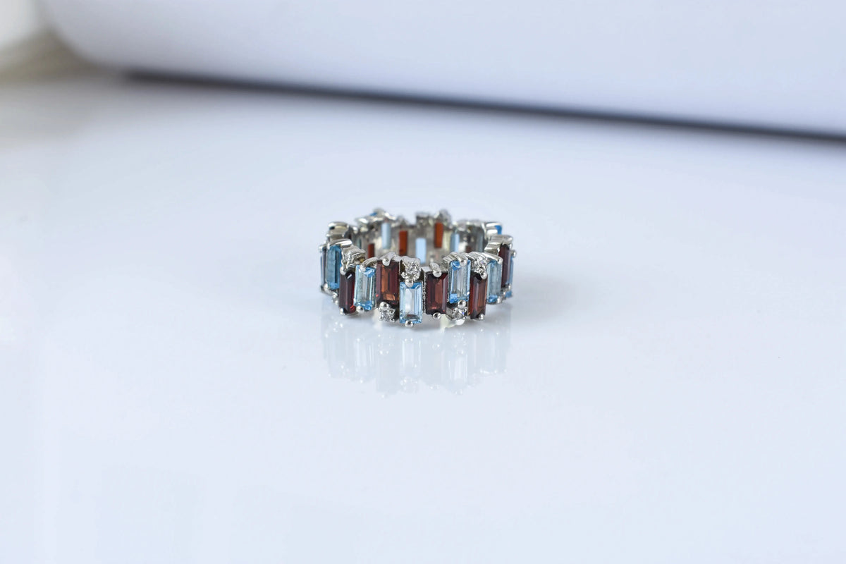 Multi gemstone baguette eternity ring with garnet and Swiss blue topaz in 925 silver