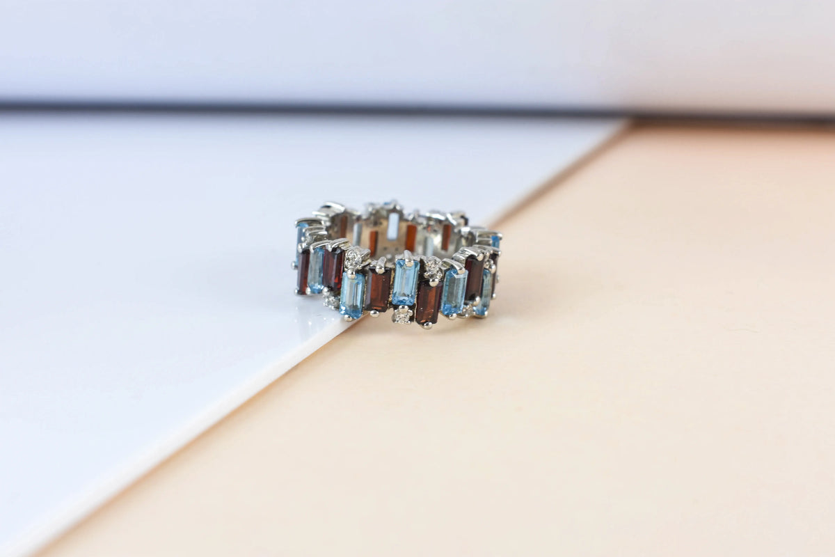 Multi gemstone baguette eternity ring with garnet and Swiss blue topaz in 925 silver