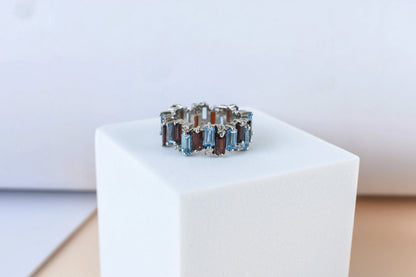 Multi gemstone baguette eternity ring with garnet and Swiss blue topaz in 925 silver