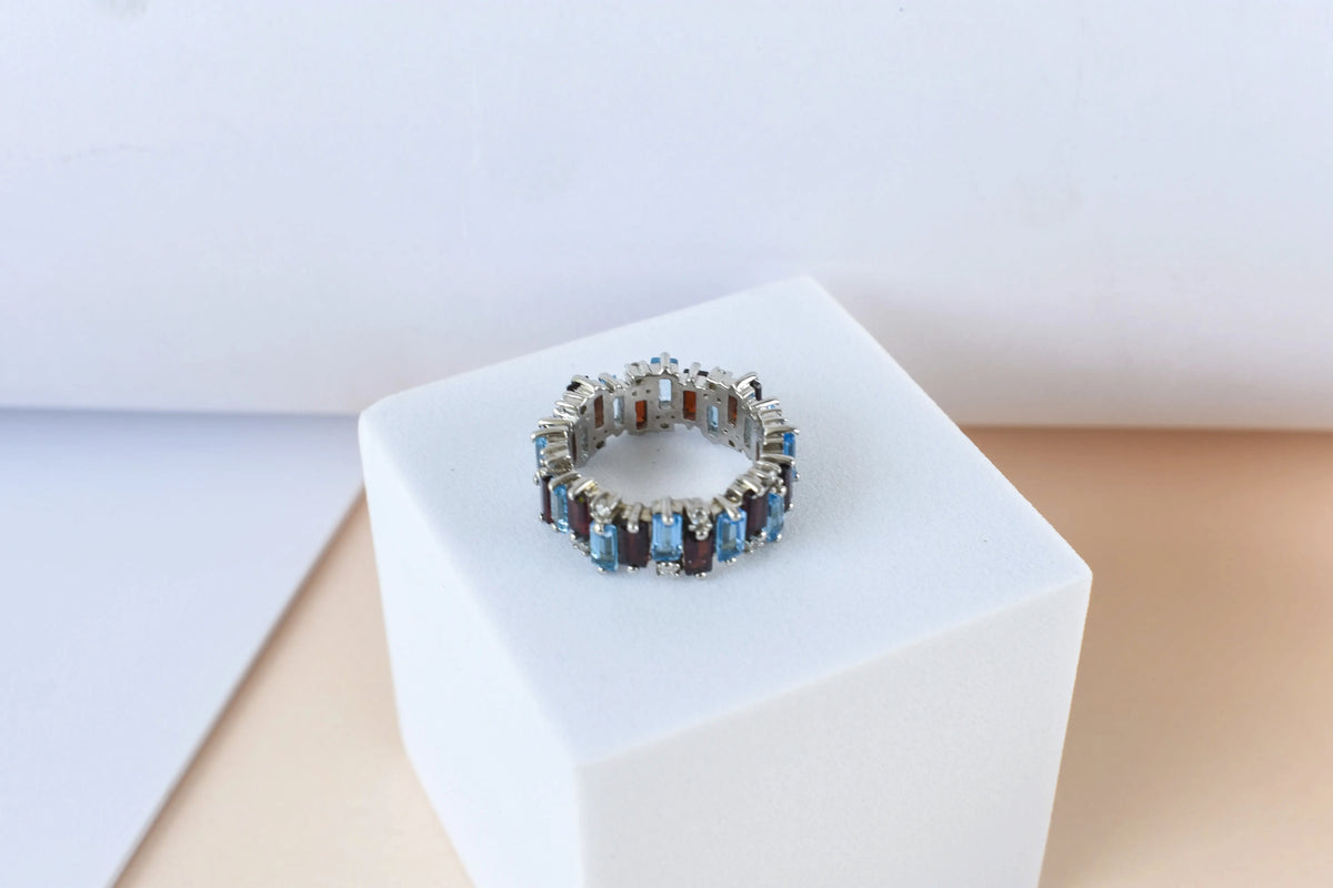 Multi gemstone baguette eternity ring with garnet and Swiss blue topaz in 925 silver