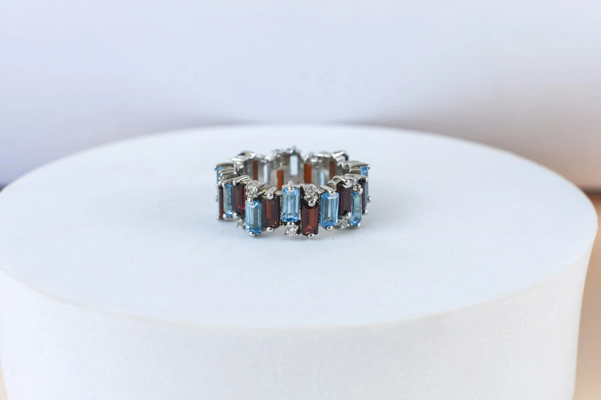 Multi gemstone baguette eternity ring with garnet and Swiss blue topaz in 925 silver