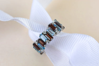 Multi gemstone baguette eternity ring with garnet and Swiss blue topaz in 925 silver