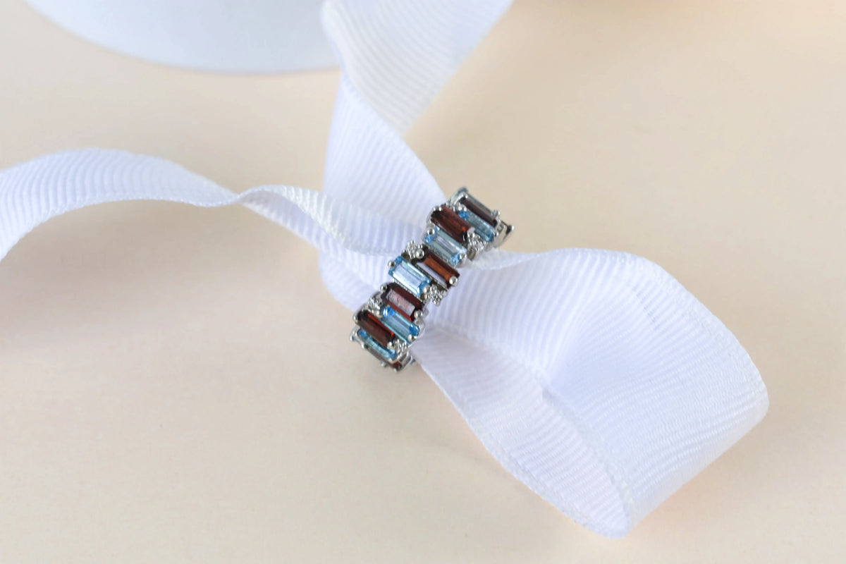 Multi gemstone baguette eternity ring with garnet and Swiss blue topaz in 925 silver