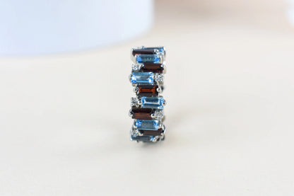 Multi gemstone baguette eternity ring with garnet and Swiss blue topaz in 925 silver