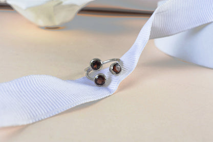 Garnet three-stone open ring in 925 silver