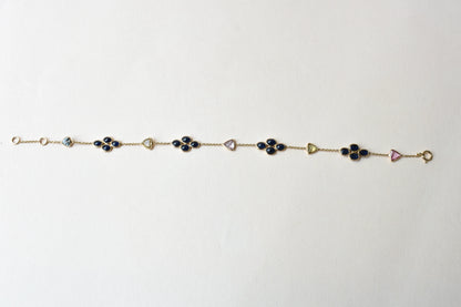 18K gold bracelet with blue sapphire clusters and multi-color trillion sapphire accents