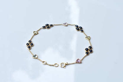 18K gold bracelet with blue sapphire clusters and multi-color trillion sapphire accents