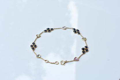18K gold bracelet with blue sapphire clusters and multi-color trillion sapphire accents