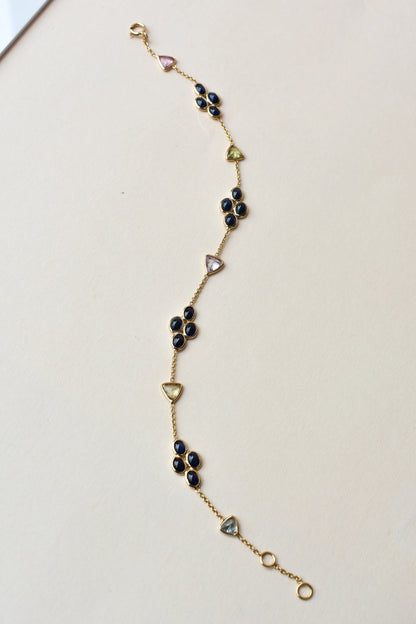 18K gold bracelet with blue sapphire clusters and multi-color trillion sapphire accents