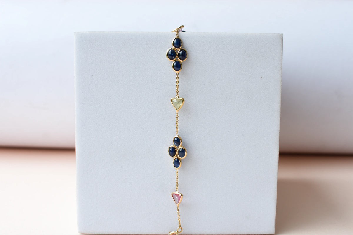 18K gold bracelet with blue sapphire clusters and multi-color trillion sapphire accents