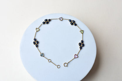 18K gold bracelet with blue sapphire clusters and multi-color trillion sapphire accents