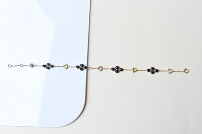 18K gold bracelet with blue sapphire clusters and multi-color trillion sapphire accents