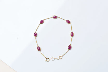 18K gold bracelet with bezel-set oval ruby stations