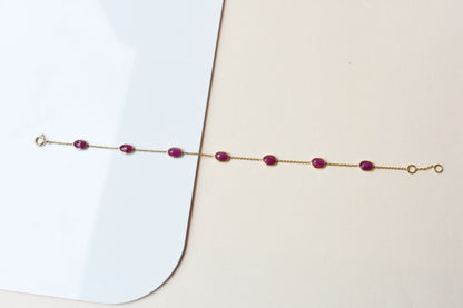 18K gold bracelet with bezel-set oval ruby stations