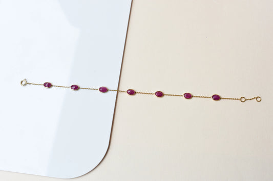 18K gold bracelet with bezel-set oval ruby stations