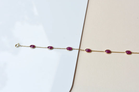 18K gold bracelet with bezel-set oval ruby stations