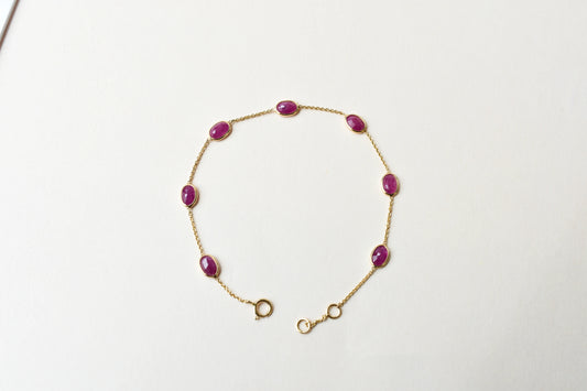 18K gold bracelet with bezel-set oval ruby stations