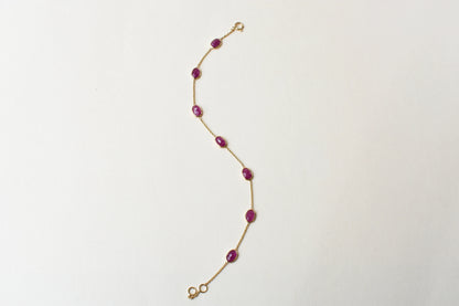 18K gold bracelet with bezel-set oval ruby stations