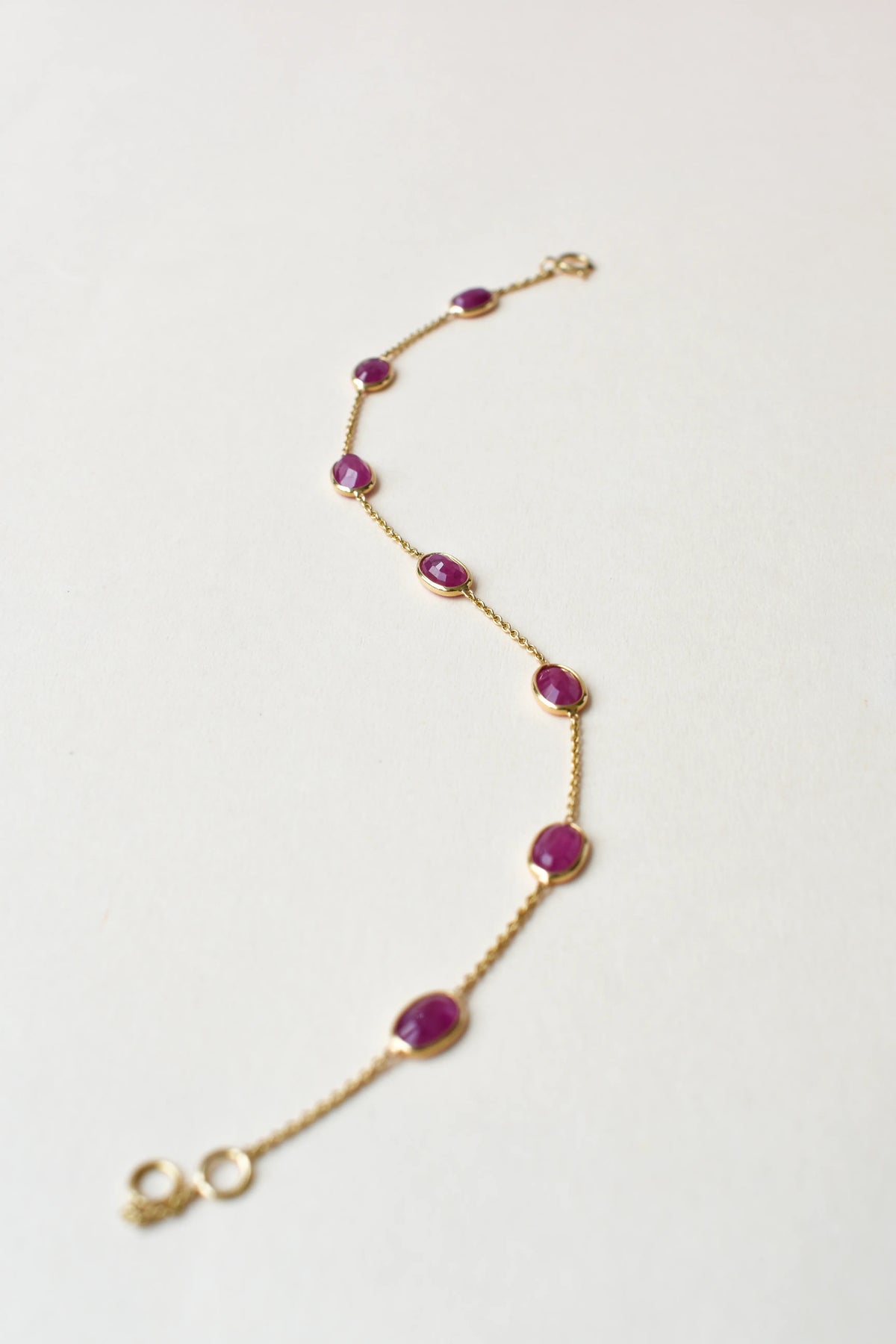 18K gold bracelet with bezel-set oval ruby stations