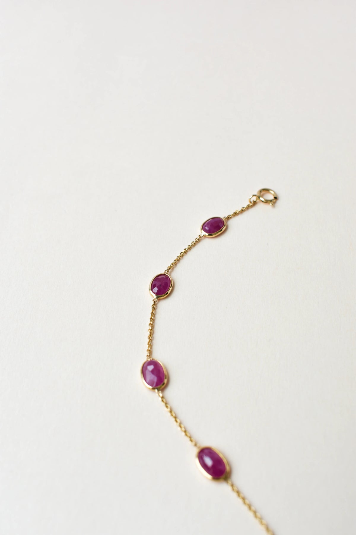 18K gold bracelet with bezel-set oval ruby stations