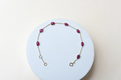 18K gold bracelet with bezel-set oval ruby stations