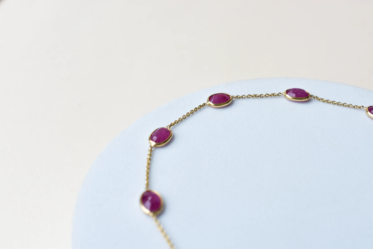 18K gold bracelet with bezel-set oval ruby stations