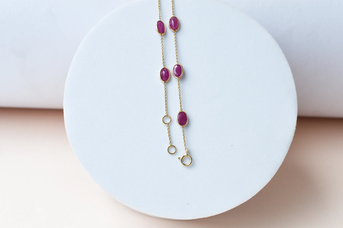 18K gold bracelet with bezel-set oval ruby stations