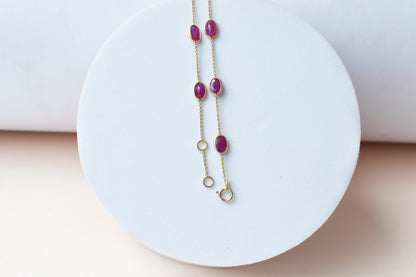 18K gold bracelet with bezel-set oval ruby stations