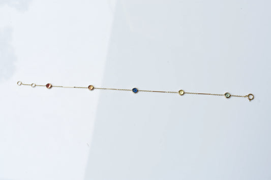 14K gold bracelet with rainbow sapphire bezels and bar links