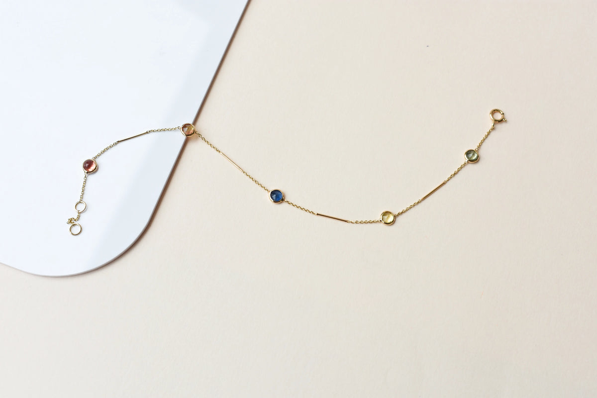 14K gold bracelet with rainbow sapphire bezels and bar links