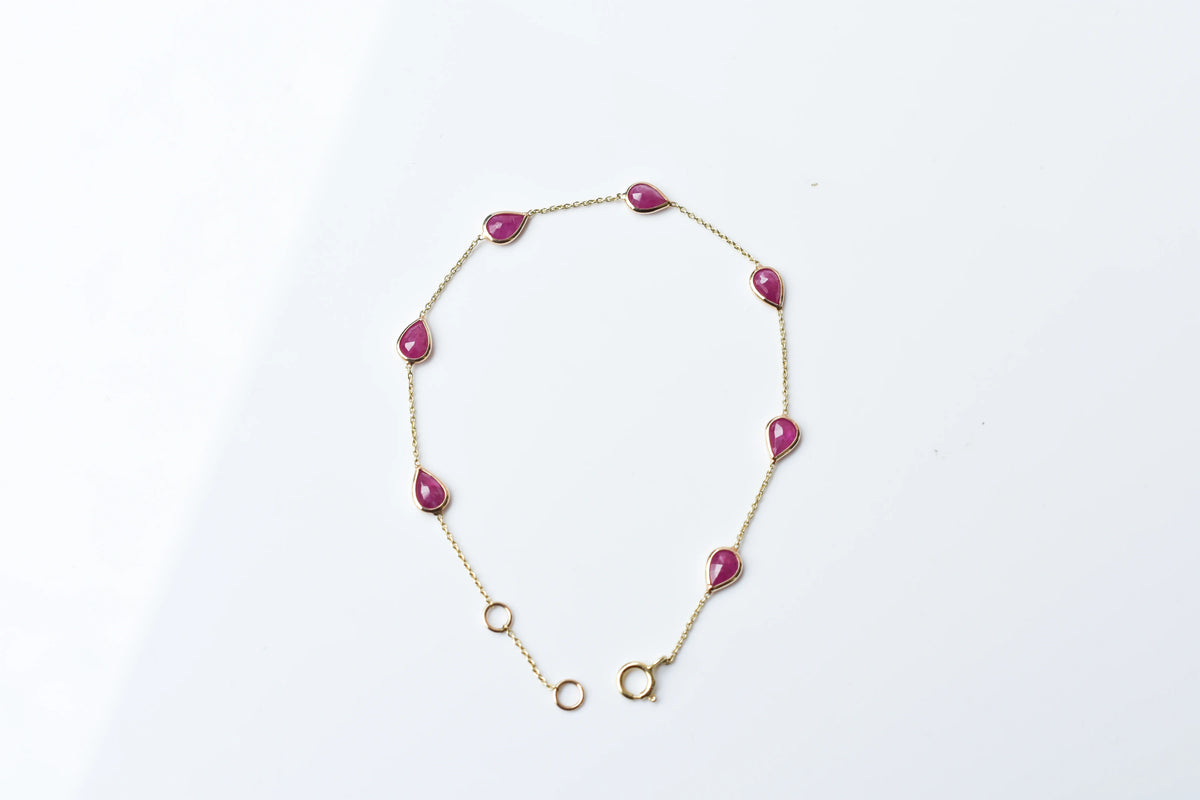 10K gold bracelet with pear-cut ruby drops