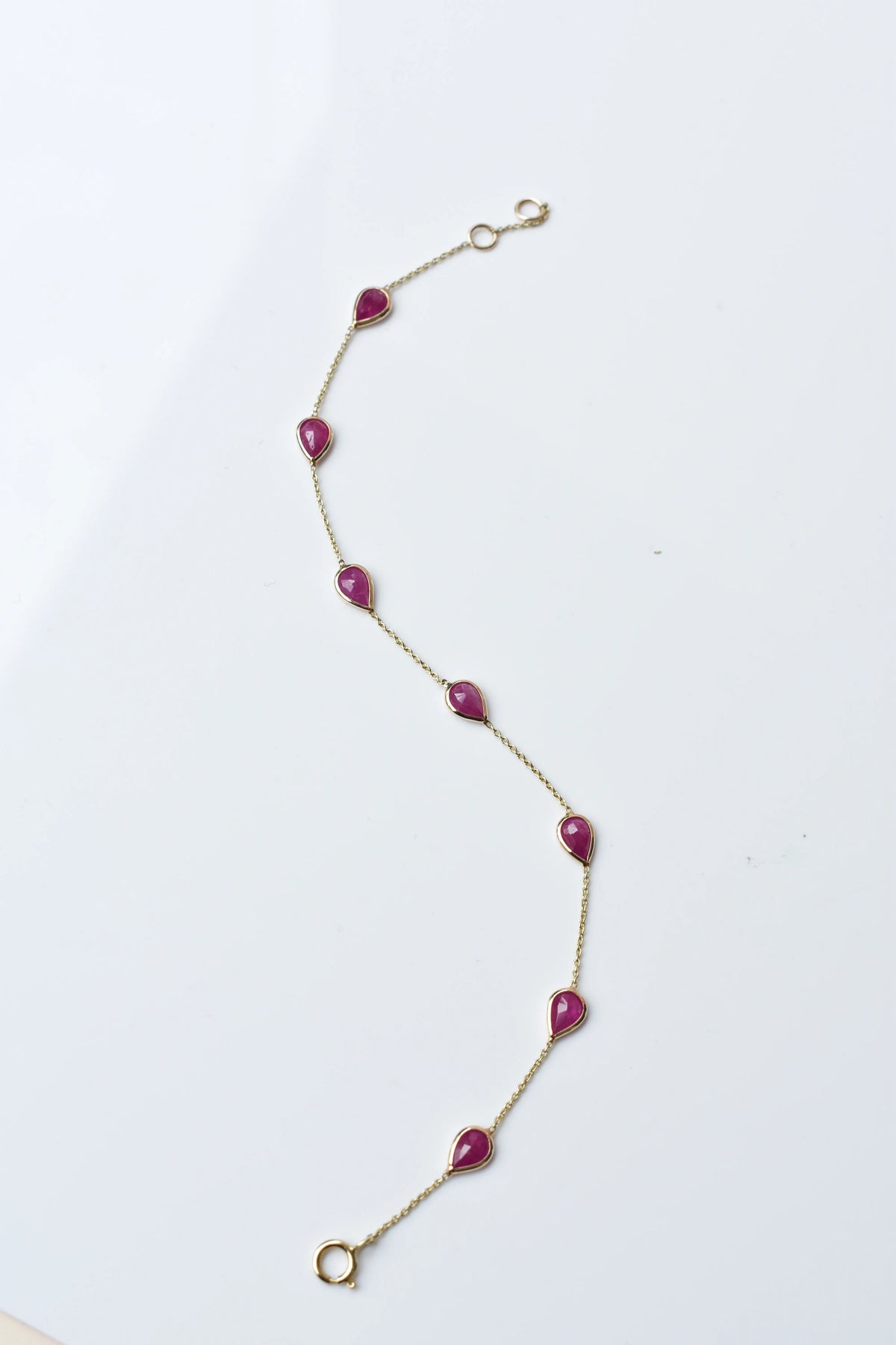 10K gold bracelet with pear-cut ruby drops