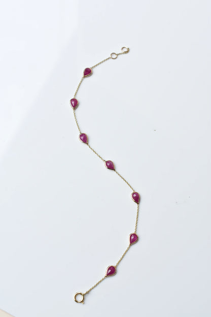 10K gold bracelet with pear-cut ruby drops