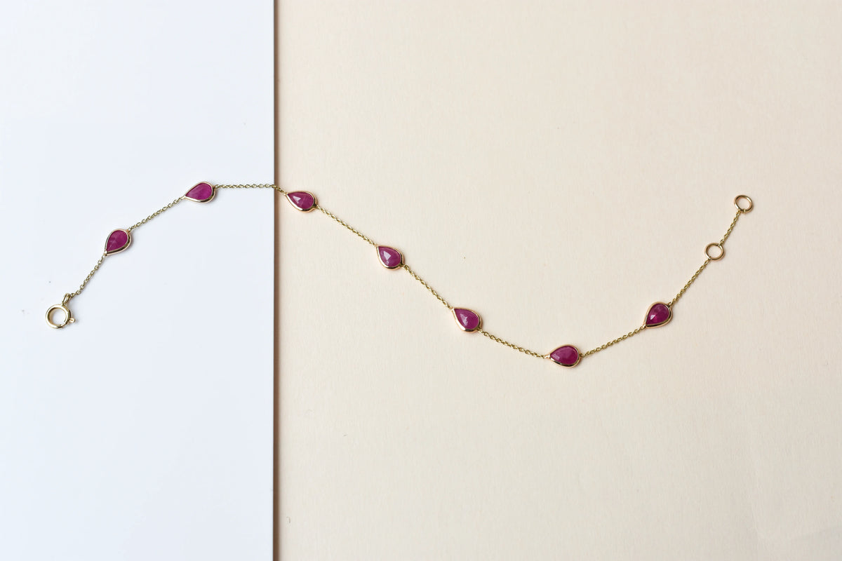 10K gold bracelet with pear-cut ruby drops