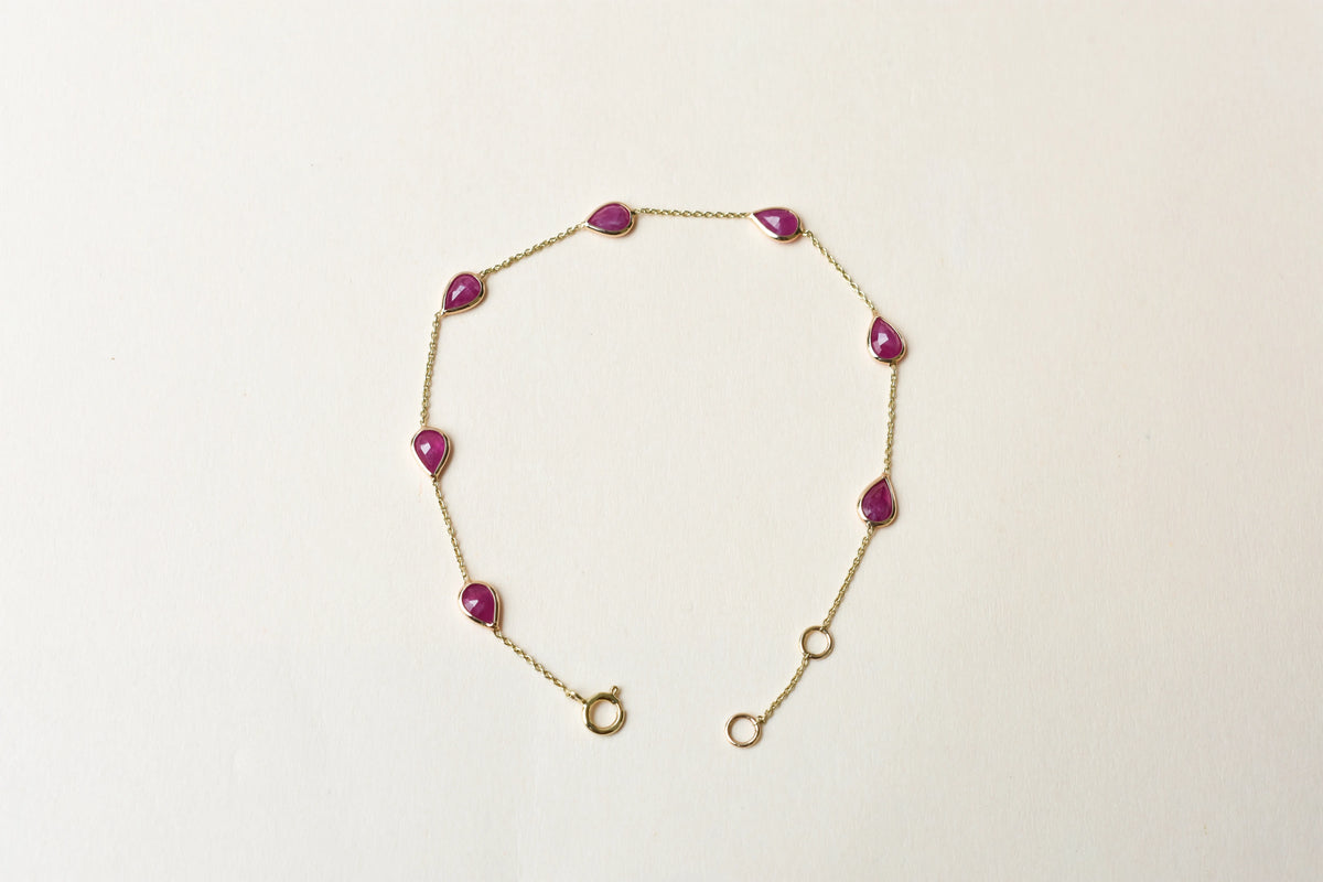 10K gold bracelet with pear-cut ruby drops