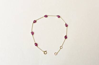 10K gold bracelet with pear-cut ruby drops