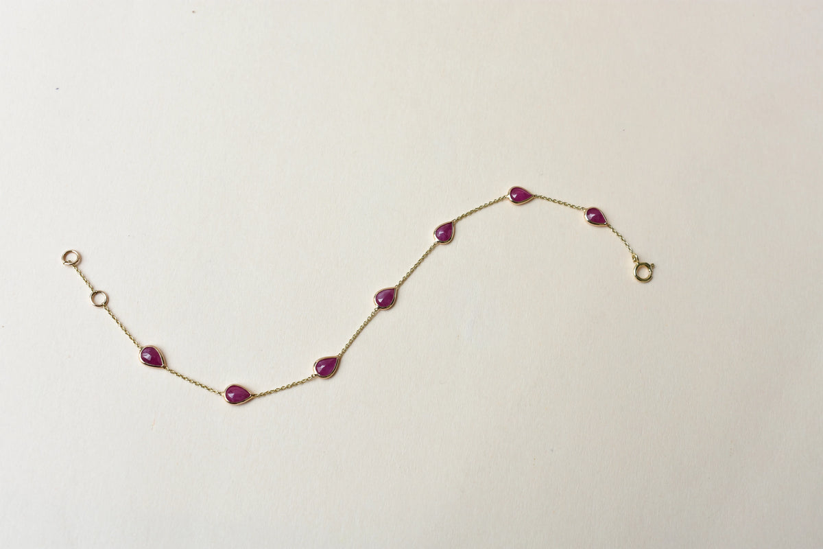 10K gold bracelet with pear-cut ruby drops