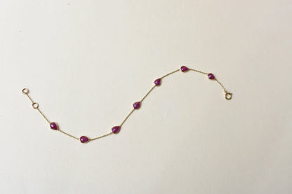 10K gold bracelet with pear-cut ruby drops