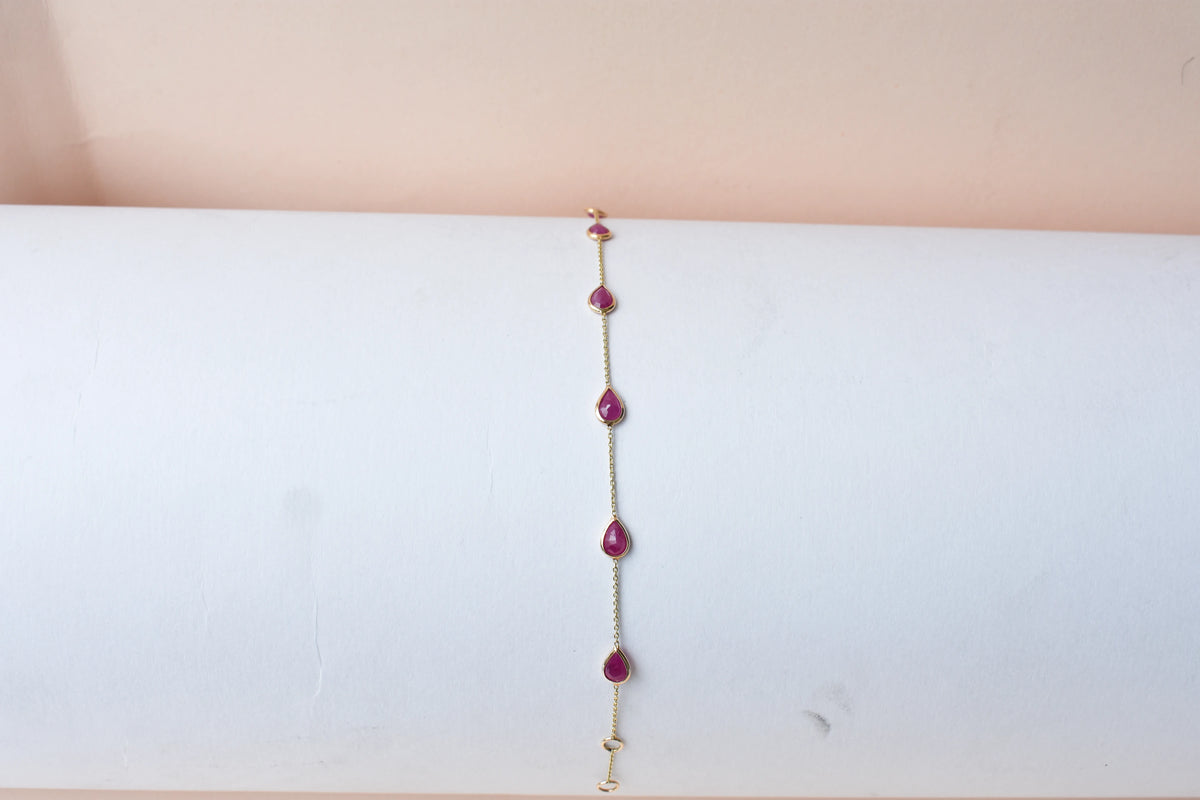 10K gold bracelet with pear-cut ruby drops