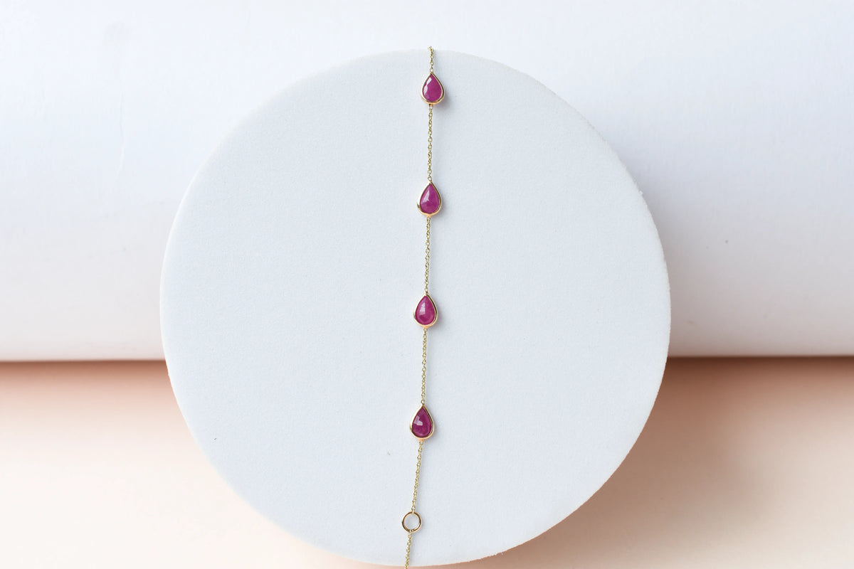 10K gold bracelet with pear-cut ruby drops