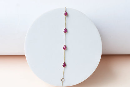 10K gold bracelet with pear-cut ruby drops
