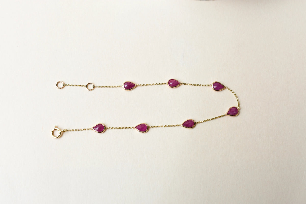 10K gold bracelet with pear-cut ruby drops