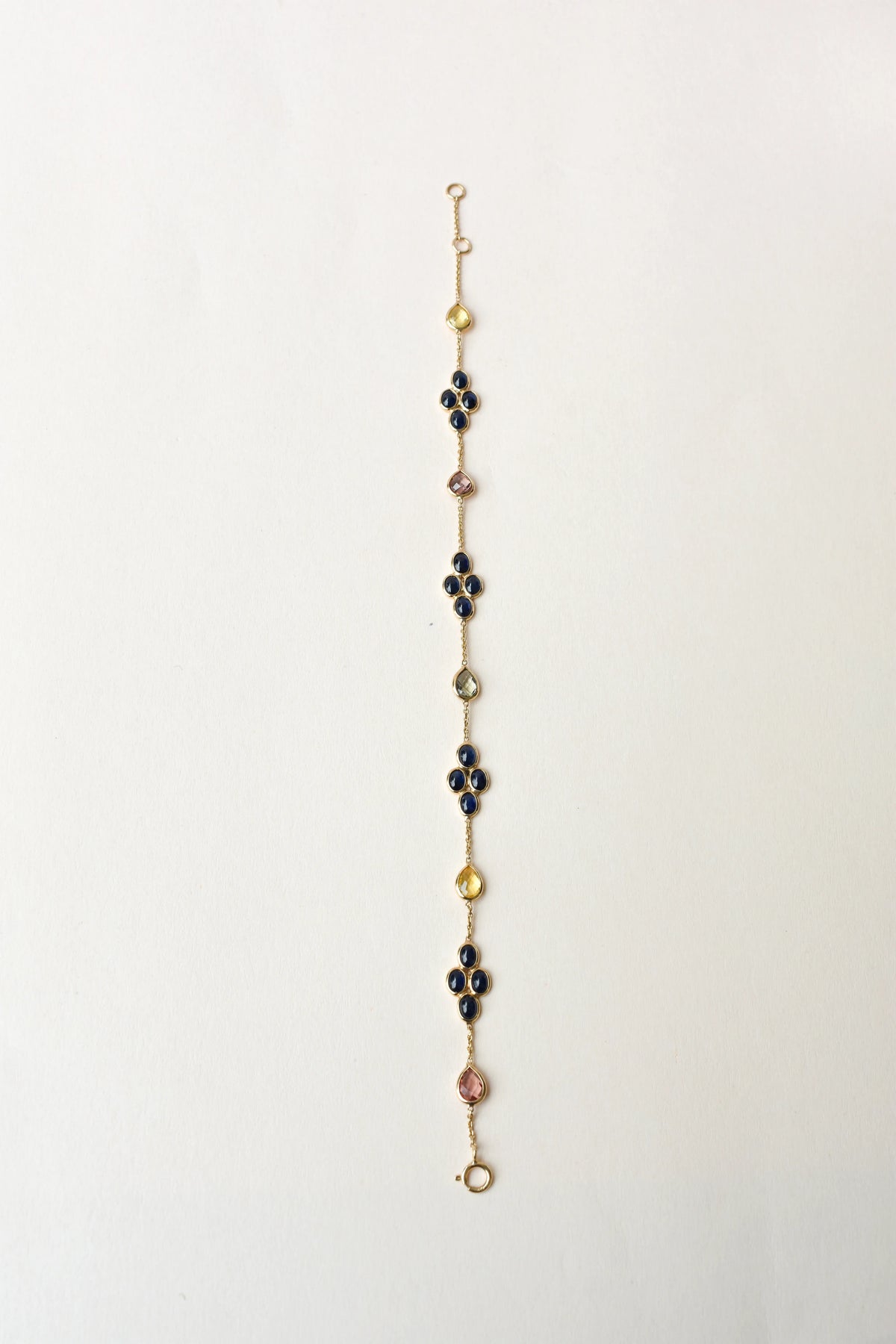 18K gold bracelet with blue sapphire clusters and multi-color sapphire accents