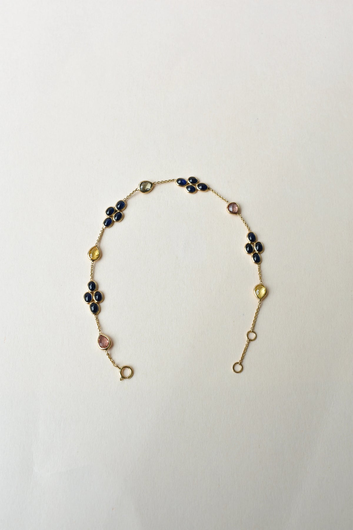 18K gold bracelet with blue sapphire clusters and multi-color sapphire accents