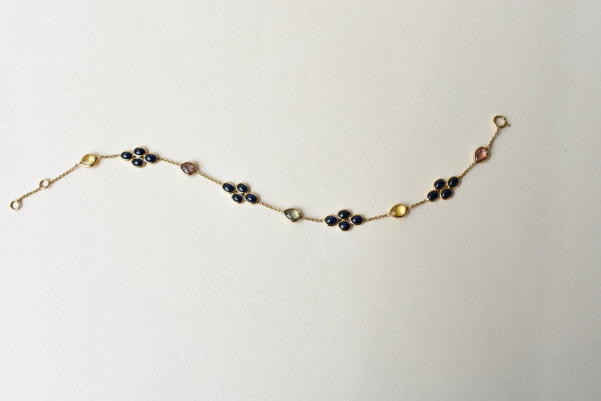 18K gold bracelet with blue sapphire clusters and multi-color sapphire accents