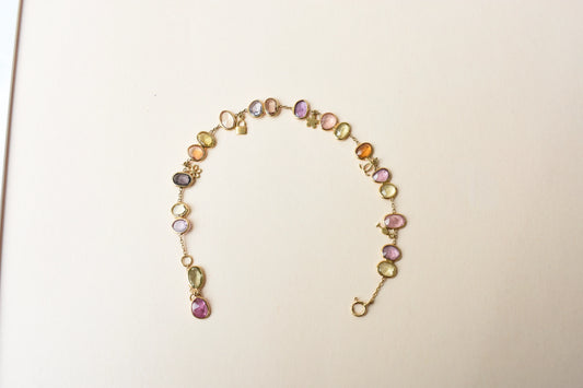 18K gold bracelet with a cluster of violet, green and pink sapphires
